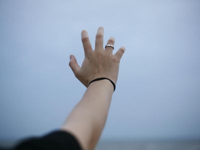Close up of a hand reaching during a stretch.